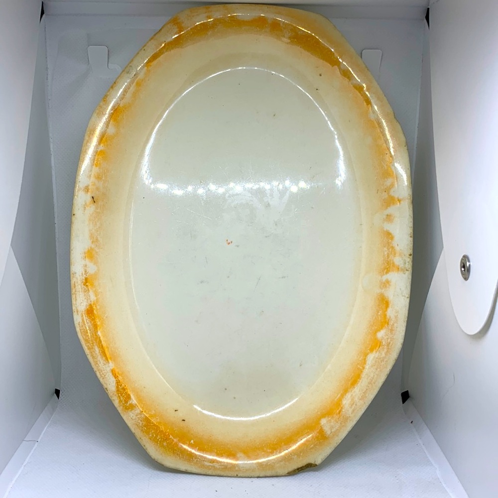 Homer Laughlin 1920’s small plater. Yellow-ish colored trim.  Chips and wear.